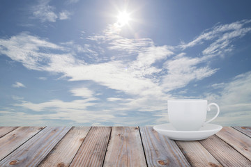 White Coffee cup on the wood table with scenery  background.