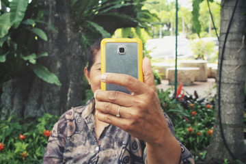 Senior woman take a photo wiht smart phone