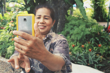 Senior woman take a photo wiht smart phone
