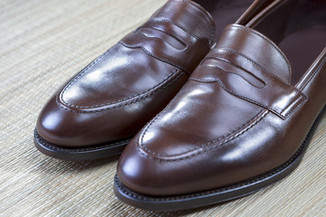 Fototapeta na wymiar Pair of Stylish and Fashinable Brown Penny Loafer Shoes.