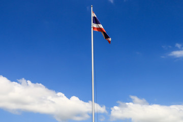 National flag of Thailand with blue sky background.