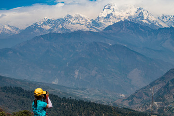 Fototapeta na wymiar A girl travel in Nepal with Himalaya in the background.