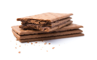 chocolate flavor sandwich biscuits with bites on a white background