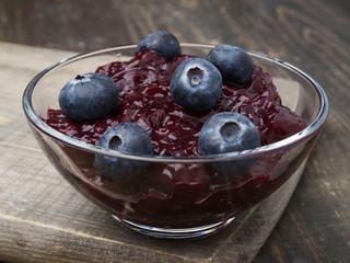 bowl with jam and blueberries, on wood