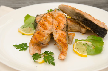 several salmon steaks white plate spices