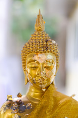Face of golden buddha sculpture, Thailand.