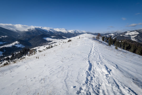 Mountaine range with snow and trails