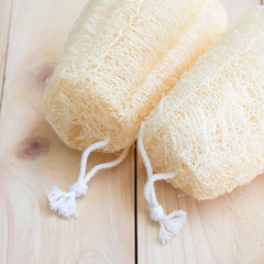 the shower equipment made from fiber of zucchini on wood pallet background