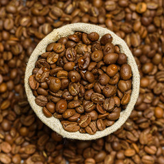 coffee beans in flax sack on grey background