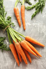 Fresh and sweet carrots on a grey table