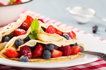 Delicious pancakes with raspberries, blueberries and strawberrie