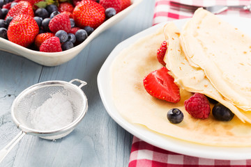 Delicious pancakes with raspberries, blueberries and strawberrie
