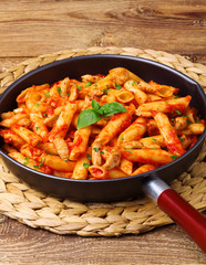 Penne with roasted chicken in tomato sauce