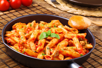 Penne with roasted chicken in tomato sauce