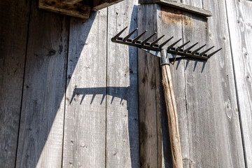 Pitchfork which hangs on a wall of an old wooden shed