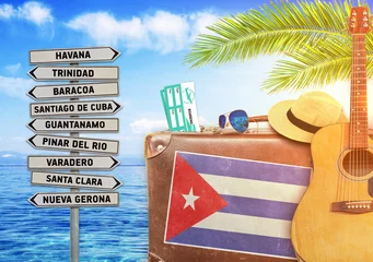 Poster Concept of summer traveling with old suitcase and Cuba town sign © bennian_1
