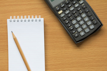 Note paper, calculator and pencil