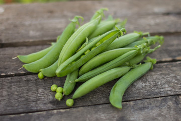Green peas on wooden background