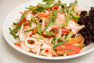  spicy salad with  squid onion, green herbs and tomato