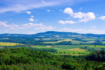 Czech landscape with mountains, clouds and trees