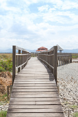 Obraz premium perspective wooden bridge with dry earth and cracked ground texture, broken split land with soil background