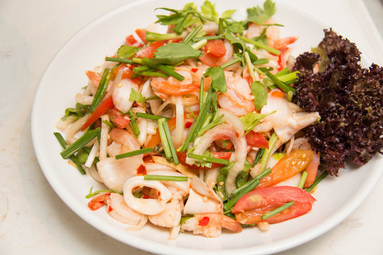  spicy salad with  squid onion, green herbs and tomato