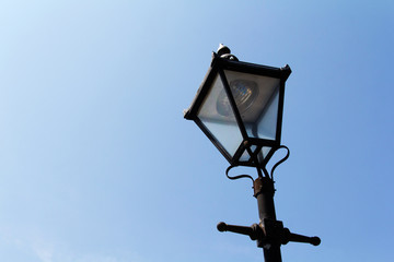 Fototapeta na wymiar Old victorian lamp post against blue sky