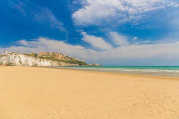 Golden sand beach of Vieste with Pizzomunno rock, Gargano peninsula, Apulia, South of Italy