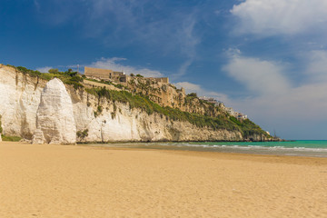 Golden sand beach of Vieste with Pizzomunno rock, Gargano peninsula, Apulia, South of Italy