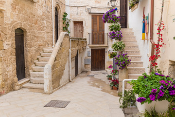 Romantic streets of Polignano a Mare old town with poems written on stairs, Apulia region, South of Italy