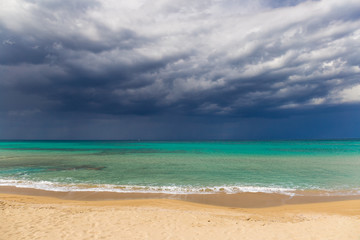Fototapeta na wymiar Amazing golden sand beach near Monopolli Capitolo, amazing atmosphere during stormy day, Apulia region, Southern Italy