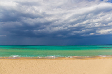 Amazing golden sand beach near Monopolli Capitolo, amazing atmosphere during stormy day, Apulia region, Southern Italy
