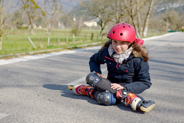 teenage skater grimacing in pain after taking fall