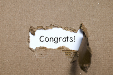 The word congrats appearing behind torn paper.