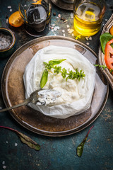 Handmade ricotta cheese on dark rustic kitchen table with italian food ingredients, close up