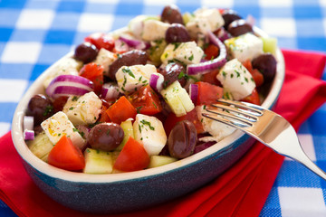 Close up of greek salad with feta cheese olives tomatoes cucumbe