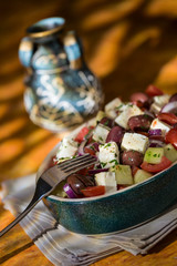 Greek salad with feta cheese tomatoes cucumber olives and onions