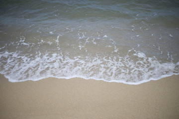 close up of wave of the sea on the sand beach.