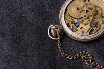 old clock mechanism on black leather background