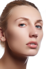 Fototapeta premium Beautiful face of young adult woman with clean fresh skin - isolated on white background