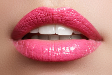Perfect smile. Beautiful full pink lips and white teeth. Pink lipstick. Gloss lips. Make-up & Cosmetics

