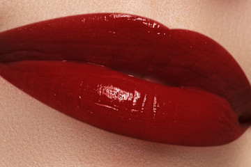 Close-up of woman's lips with fashion dark red lipstick makeup.