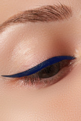 Cosmetics and make-up. Beautiful female eye with sexy black liner makeup. Fashion big arrow shape...