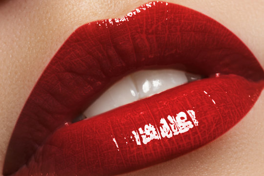 Close-up of woman's lips with fashion dark red lipstick makeup.