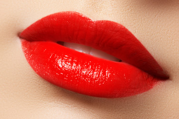 Obraz premium Close-up shot of woman lips with red lipstick. Beautiful perfect lips. Sexy mouth close up. Beautiful wide smile of young fresh woman with full lips