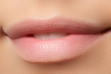 Part of face, young woman close-up. Sexy plump lips without make-up