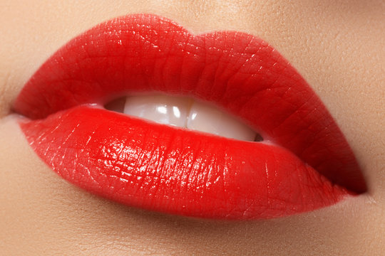 Close-up shot of woman lips with red lipstick. Beautiful perfect lips. Sexy mouth close up. Beautiful wide smile of young fresh woman with full lips

