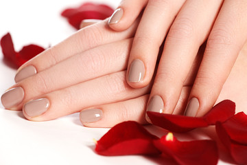 Fototapeta premium Beautiful female finger nails with natural nail closeup on petal
