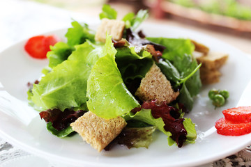 Green salad with strawberry pieces and a dressing of orange juic