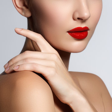 Beautiful young model with red lips and french manicure